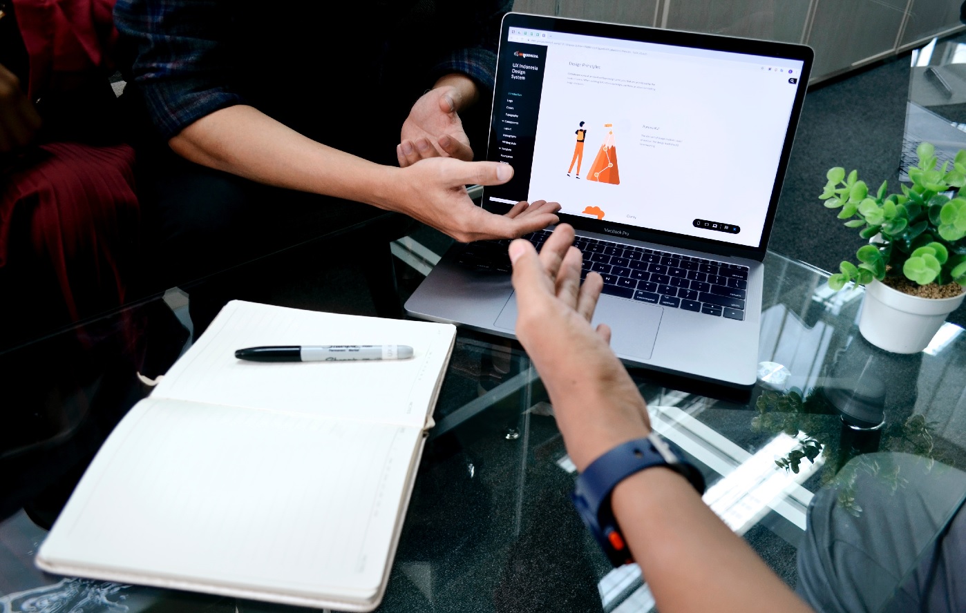 Customer service worker discussing over laptop